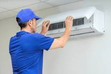 Professional AC technician installing split AC unit